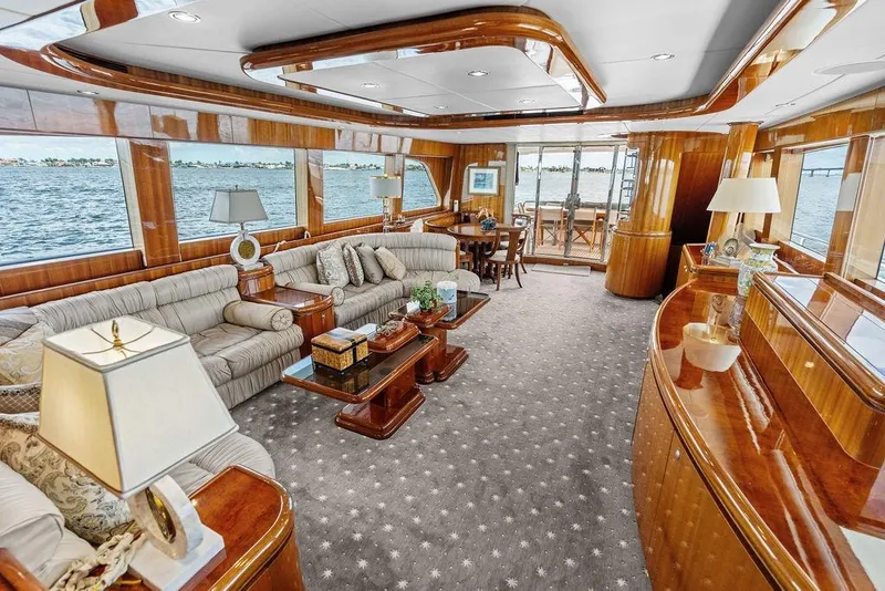 Slide: The Image of Luxurious 2005 Horizon 82 yacht interior with elegant wood finishes and plush seating. - 26