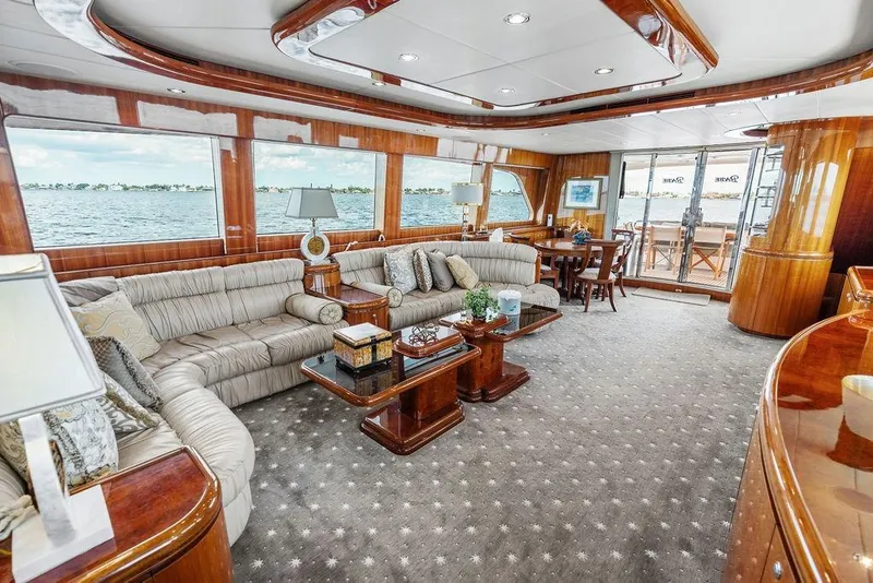 Slide: The Image of Luxurious 2005 Horizon 82 yacht interior with elegant wood finishes and spacious seating area. - 28