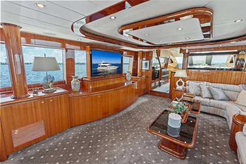 Slide: The Image of Luxurious 2005 Horizon 82 yacht interior with elegant wood finishes and plush seating. - 31