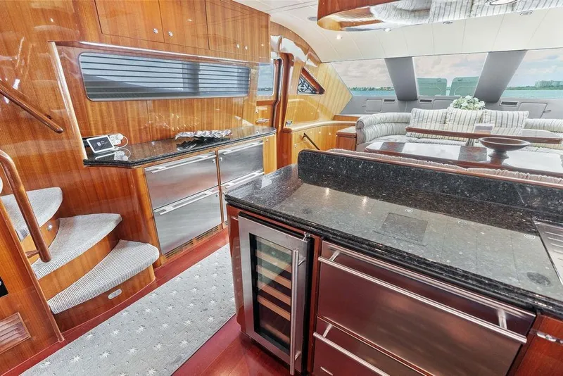 Slide: The Image of Luxurious 2005 Horizon 82 yacht interior with elegant wood finishes and modern kitchen amenities. - 35