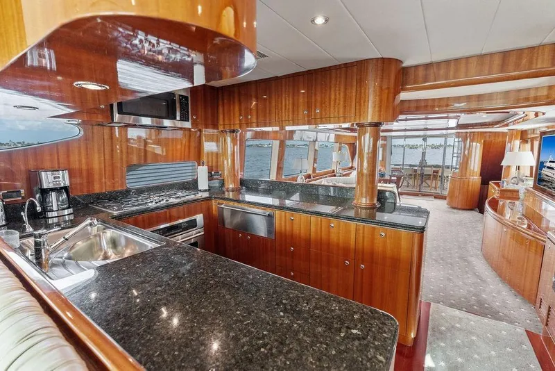 Slide: The Image of Luxurious 2005 Horizon 82 yacht interior with modern kitchen and elegant wood finishes. - 36