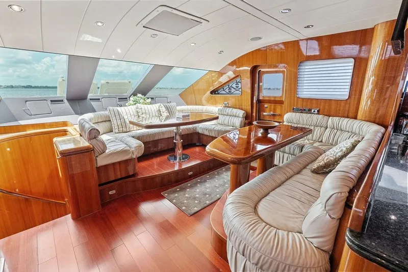 Slide: The Image of Luxurious interior of a 2005 Horizon 82 yacht with plush seating and wooden finishes. - 37