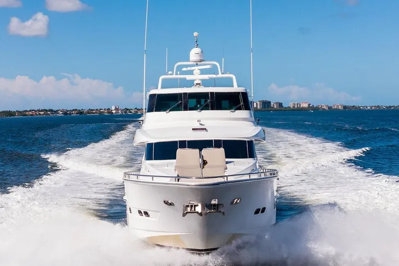 Slide: The Image of Luxurious 2005 Horizon 82 yacht cruising on open water under clear blue skies. - 4