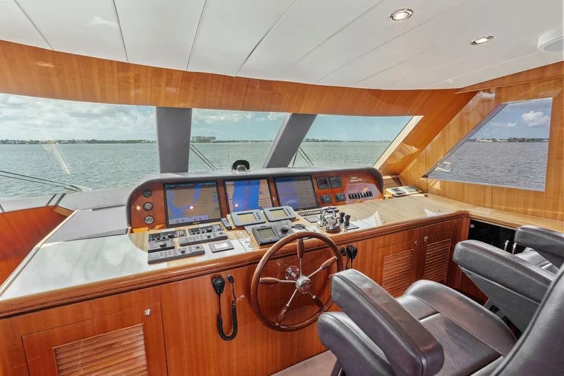 Slide: The Image of Luxurious 2005 Horizon 82 yacht helm with wooden dashboard and panoramic sea view. - 42