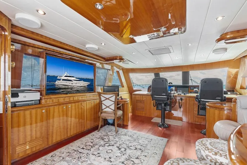 Slide: The Image of Luxurious 2005 Horizon 82 yacht interior with wood finishes and modern navigation equipment. - 49