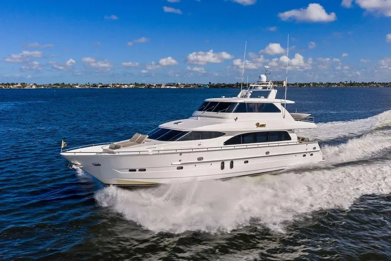 Slide: The Image of Luxurious 2005 Horizon 82 yacht cruising on open water under a clear blue sky. - 5