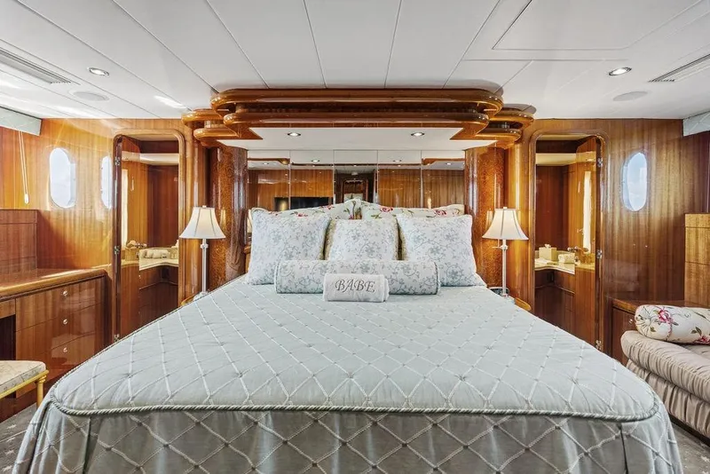 Slide: The Image of Luxurious bedroom interior on 2005 Horizon 82 yacht with elegant wood paneling and plush bedding. - 52
