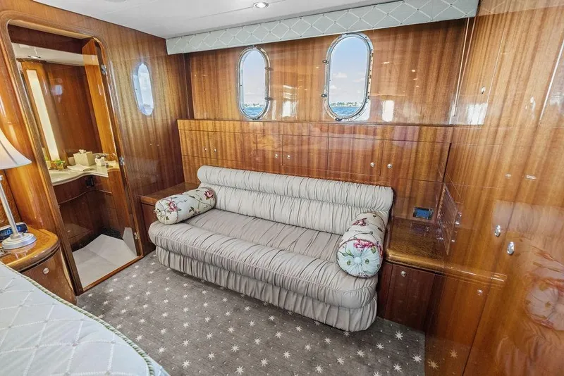 Slide: The Image of Luxurious cabin interior of 2005 Horizon 82 yacht with elegant wood paneling and plush seating. - 54