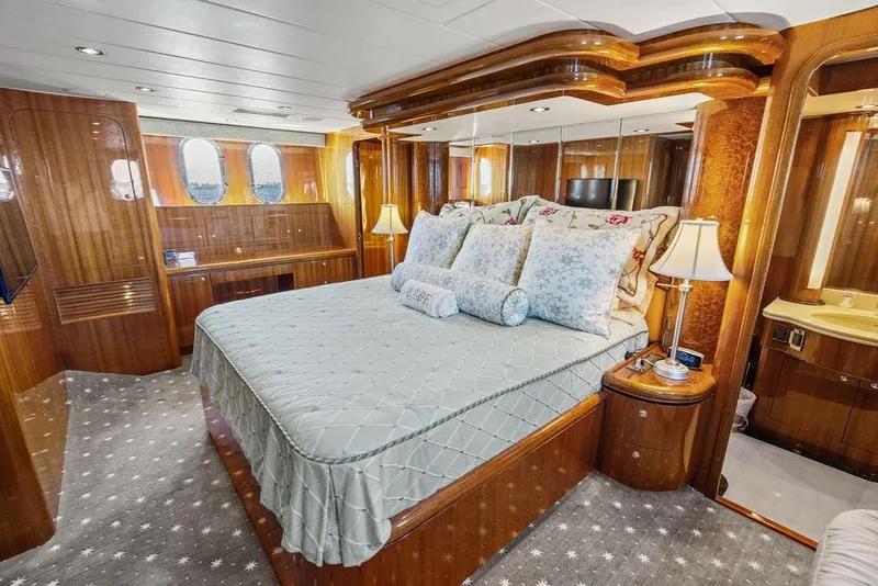 Slide: The Image of Luxurious bedroom interior on 2005 Horizon 82 yacht with elegant wood finishes and plush bedding. - 56