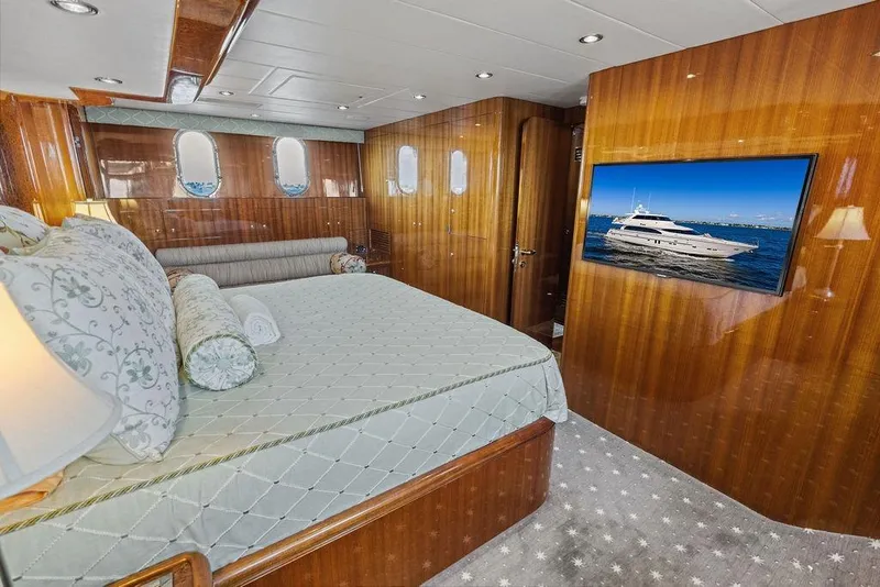 Slide: The Image of Luxurious yacht bedroom interior with wood paneling, TV, and elegant bedding, Horizon 82, 2005 model. - 58