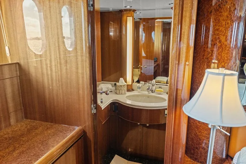 Slide: The Image of Luxurious wooden interior of a 2005 Horizon 82 yacht bathroom with elegant fixtures. - 59