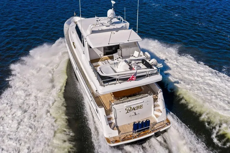 Slide: The Image of Luxurious 2005 Horizon 82 yacht cruising swiftly on open water. - 6