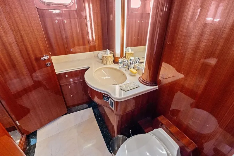 Slide: The Image of Luxurious wooden bathroom interior on 2005 Horizon 82 yacht, featuring elegant fixtures and cabinetry. - 61