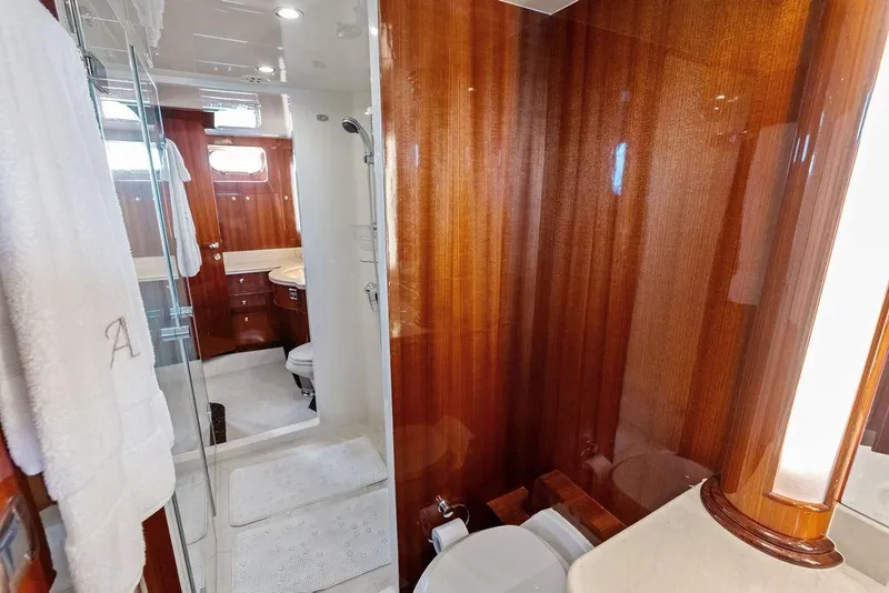 Slide: The Image of Luxurious yacht bathroom with wooden paneling, glass shower, and elegant fixtures, Horizon 82 model, 2005. - 62
