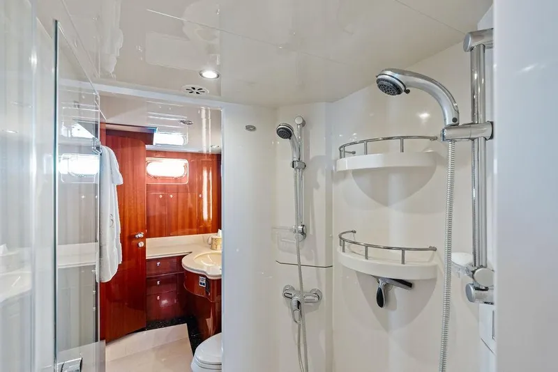 Slide: The Image of Luxurious bathroom interior on a 2005 Horizon 82 yacht, featuring modern fixtures and wood accents. - 63