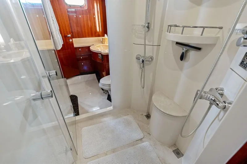 Slide: The Image of Luxurious bathroom on 2005 Horizon 82 yacht with shower and wooden cabinetry. - 64