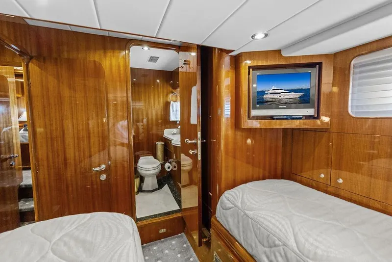 Slide: The Image of Luxurious cabin interior of 2005 Horizon 82 yacht with wood paneling and ensuite bathroom. - 66