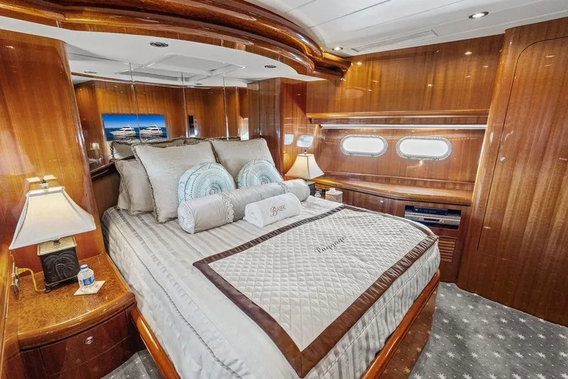 Slide: The Image of Luxurious bedroom interior on 2005 Horizon 82 yacht with elegant wood paneling. - 70