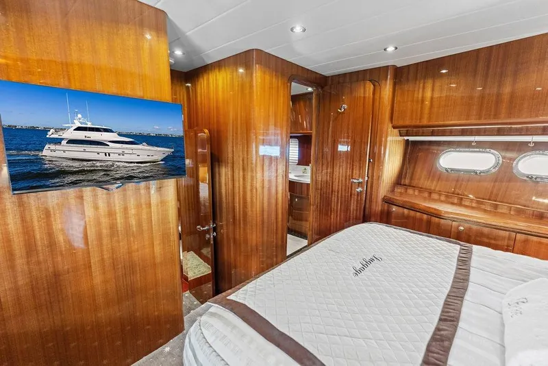 Slide: The Image of Luxurious cabin interior of 2005 Horizon 82 yacht with wood paneling and porthole windows. - 71