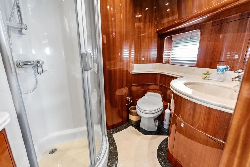 Slide: The Image of Luxurious yacht bathroom with wood accents, shower, and modern fixtures, Horizon 82, 2005 model. - 72