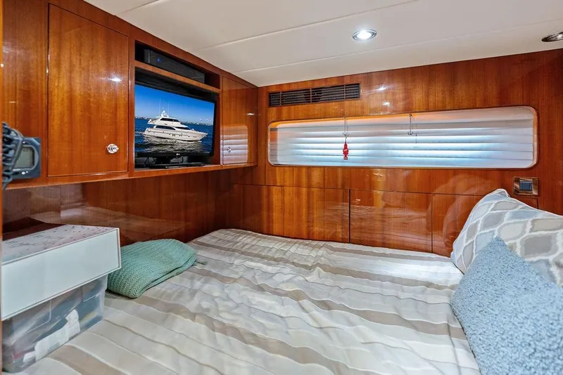 Slide: The Image of Luxurious cabin interior of 2005 Horizon 82 yacht with wood paneling and cozy bedding. - 74