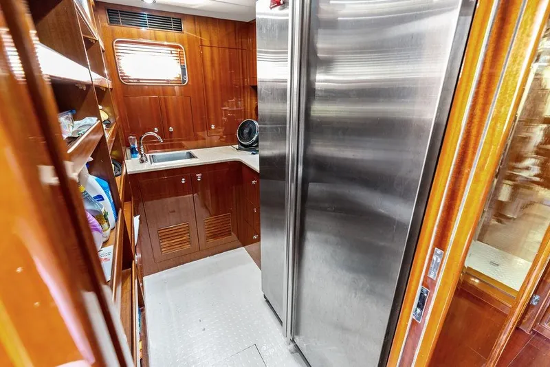 Slide: The Image of Luxurious yacht kitchen with stainless steel appliances, wooden cabinetry, and modern fixtures, Horizon 82, 2005. - 76