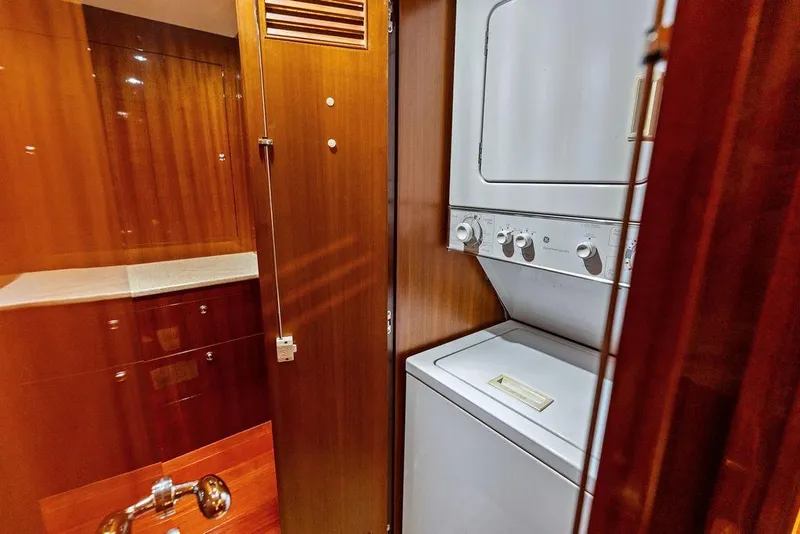 Slide: The Image of Laundry area with stacked washer and dryer in 2005 Horizon 82 yacht. - 77
