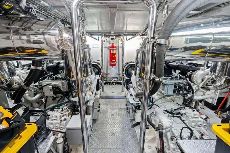 Slide: The Image of Engine room of a 2005 Horizon 82 yacht, featuring polished metal components and machinery. - 79