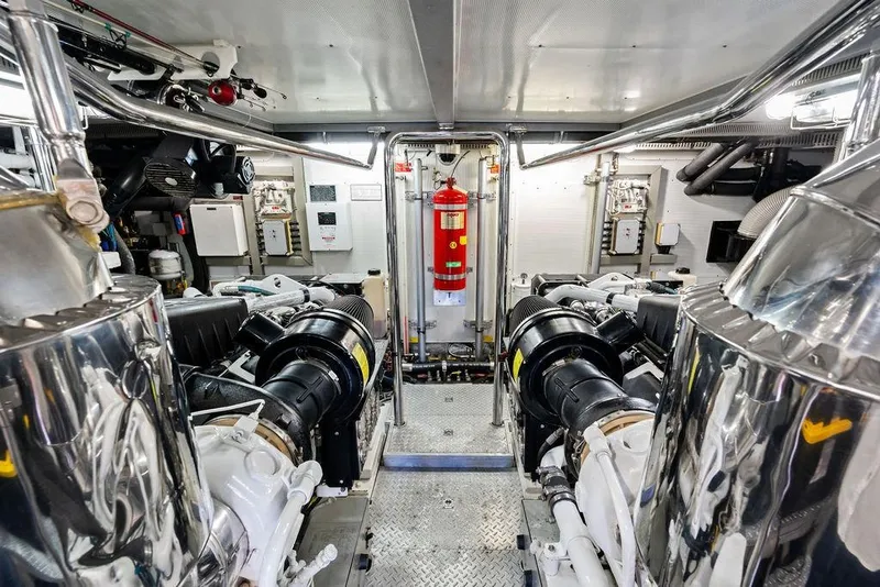 Slide: The Image of Engine room of a 2005 Horizon 82 yacht, featuring polished machinery and fire safety equipment. - 80