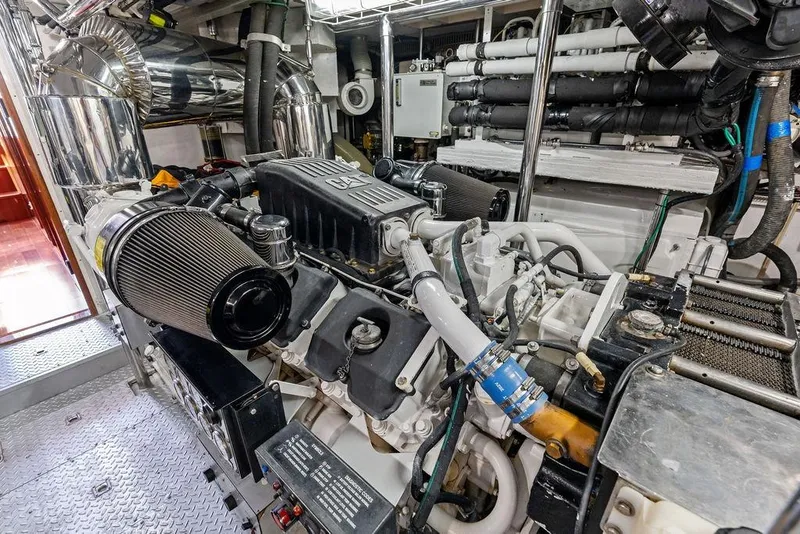 Slide: The Image of Engine room of a 2005 Horizon 82 yacht, showcasing complex machinery and components. - 82