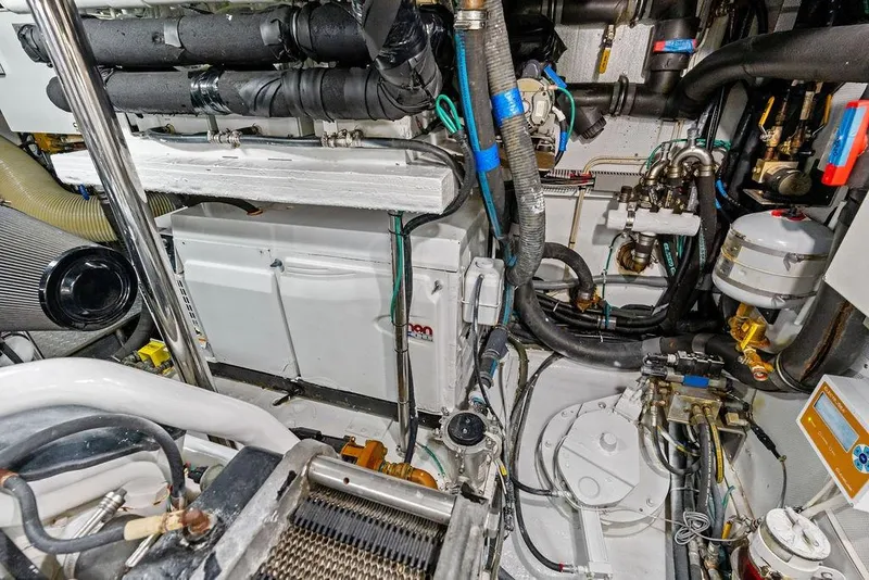 Slide: The Image of Engine room of a 2005 Horizon 82 yacht, showcasing complex machinery and piping systems. - 83