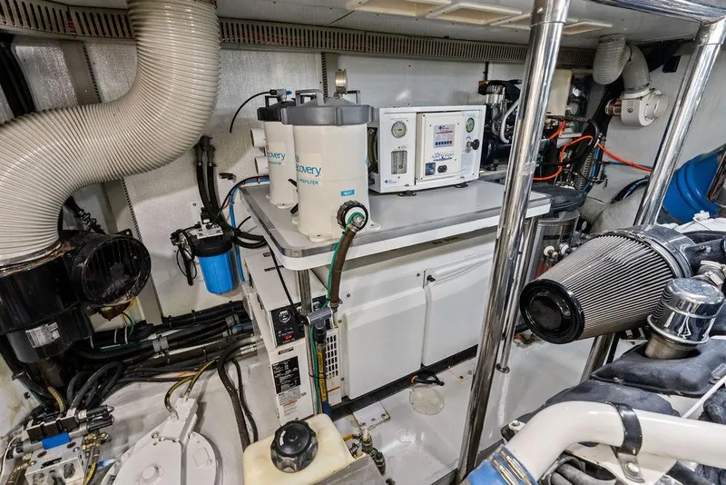 Slide: The Image of Engine room of a 2005 Horizon 82 yacht with filtration systems and machinery. - 84