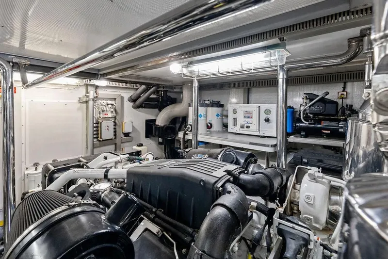 Slide: The Image of Engine room of a 2005 Horizon 82 yacht, showcasing machinery and equipment. - 85