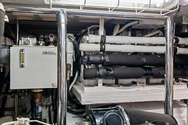 Slide: The Image of Engine room of a 2005 Horizon 82 yacht with pipes and machinery. - 87
