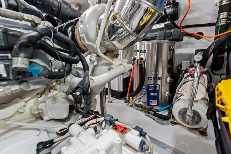 Slide: The Image of Engine room of 2005 Horizon 82 yacht with Torrid water heater and mechanical components. - 88