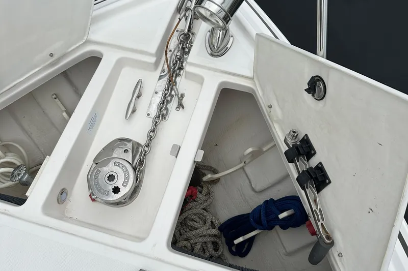 Slide: The Image of Anchor storage compartment on a 2016 Regal 35 Sport Coupe boat, featuring chains and ropes. - 48