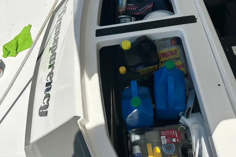 Slide: The Image of Storage compartment of 2016 Regal 35 Sport Coupe with various maintenance supplies. - 51