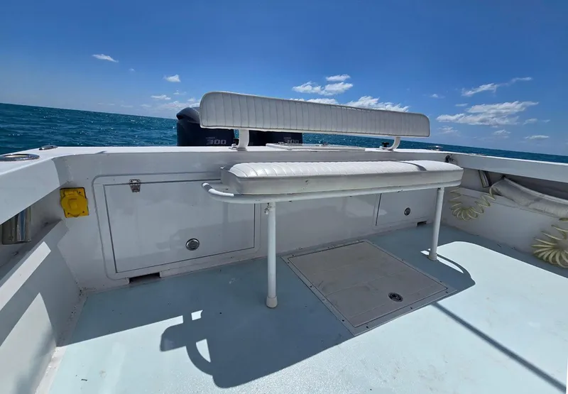Slide: The Image of 2012 Contender Custom 33 Center Console boat with white seating, ocean view, and clear sky. - 23