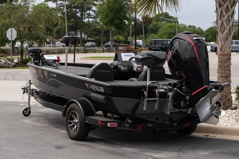 Slide: The Image of 2023 Vexus AVX1880 boat on trailer, parked outdoors near palm tree. - 4