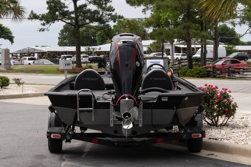 Slide: The Image of 2023 Vexus AVX1880 boat parked outdoors, showcasing rear view and motor. - 5