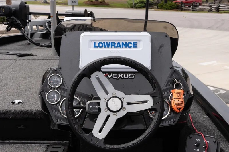 Slide: The Image of 2023 Vexus AVX1880 boat dashboard with Lowrance Elite display and steering wheel. - 8