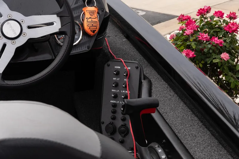 Slide: The Image of 2023 Vexus AVX1880 boat cockpit with steering wheel and control panel, near blooming roses. - 9