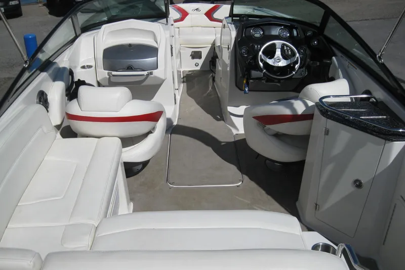 Slide: The Image of 2014 Monterey M3 Sport Boat interior with white seating and modern dashboard. - 14