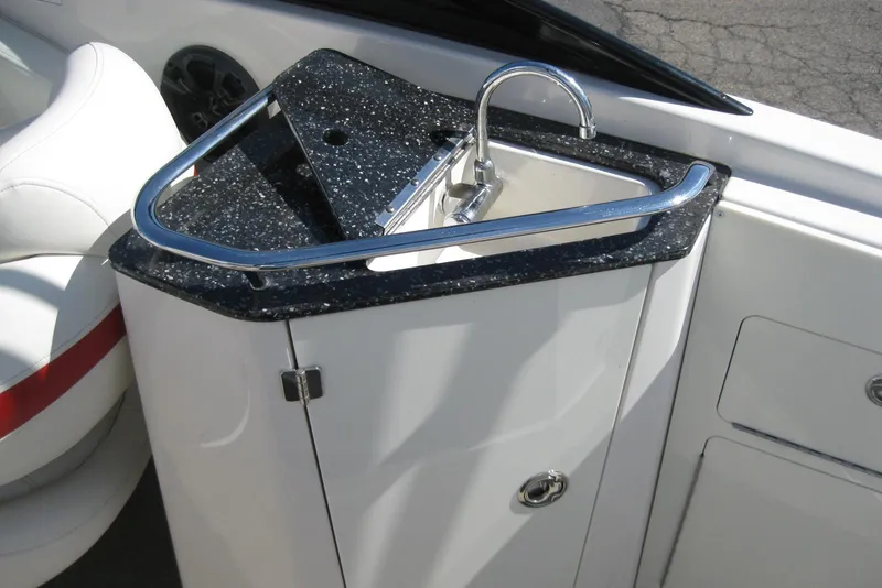 Slide: The Image of 2014 Monterey M3 Sport Boat sink with sleek black countertop and chrome faucet. - 18