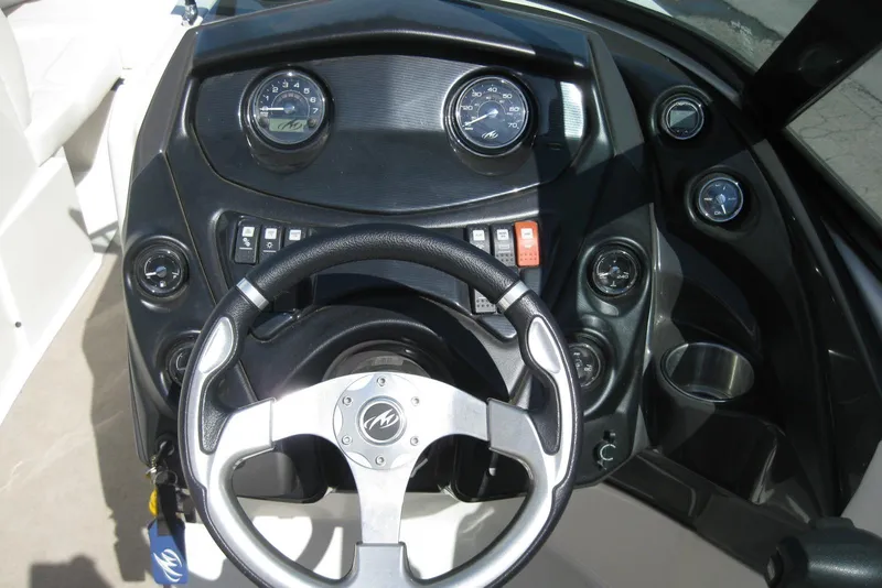 Slide: The Image of Dashboard of a 2014 Monterey M3 Sport Boat with steering wheel and gauges. - 22