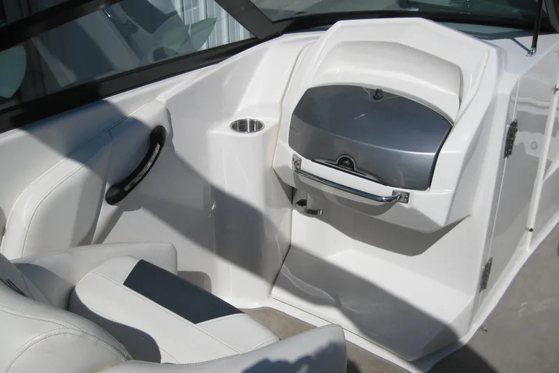 Slide: The Image of Interior of a 2014 Monterey M3 Sport Boat, featuring sleek white seating and a storage compartment. - 25
