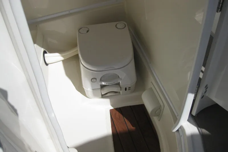 Slide: The Image of Portable toilet in 2014 Monterey M3 Sport Boat cabin, featuring compact design and wooden flooring. - 26