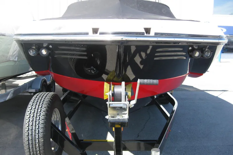 Slide: The Image of 2014 Monterey M3 Sport Boat on trailer, showcasing sleek black and red hull design. - 34