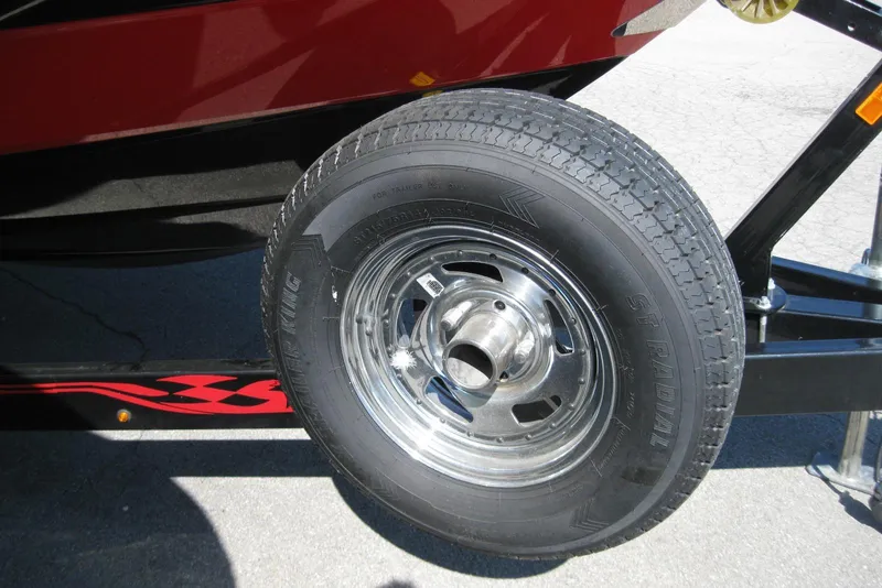 Slide: The Image of Close-up of a 2014 Monterey M3 Sport Boat trailer wheel with chrome rim. - 35