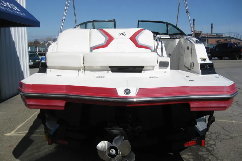 Slide: The Image of 2014 Monterey M3 Sport Boat with red and white design, rear view in a marina setting. - 8